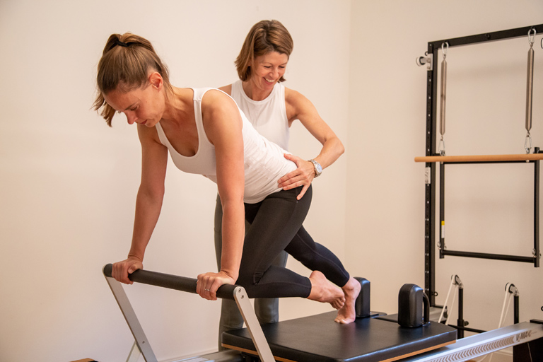 Pilates Lausanne studio private class on a reformer machine - Espace Pilates Mind Your Body